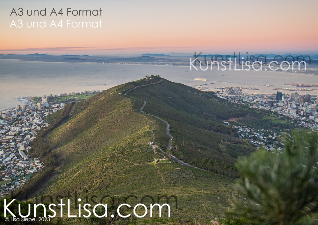 Ausblick-auf-grünen-Hügel-Signal-Hill-Kapstadt-das-Meer-und-die-Landschaft-mit-Bergen-dahinter-beim-Sonnenuntergang-in-Südafrika-Format-A3-und-A4